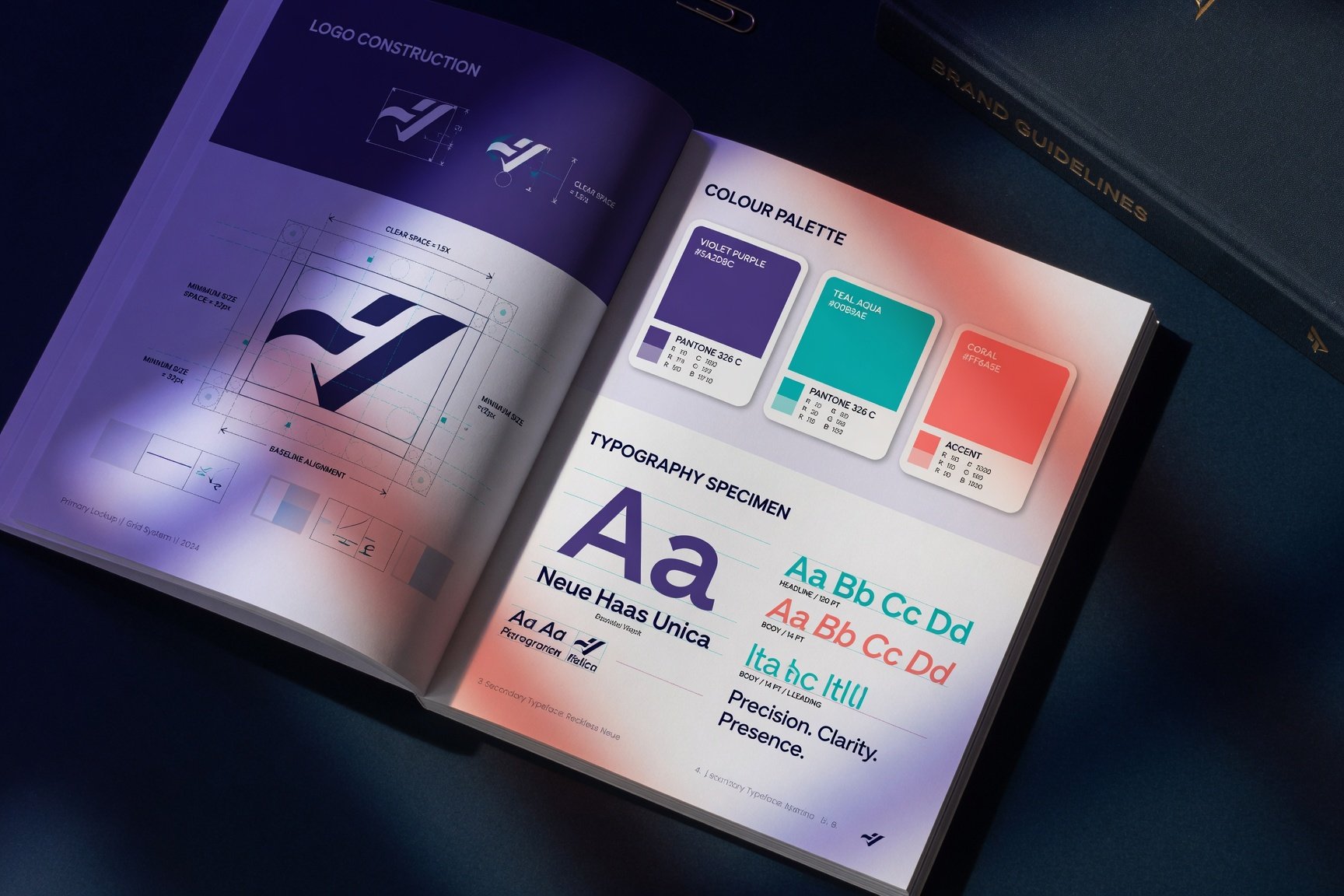 Open brand guidelines book showing logo construction, colour palette and typography